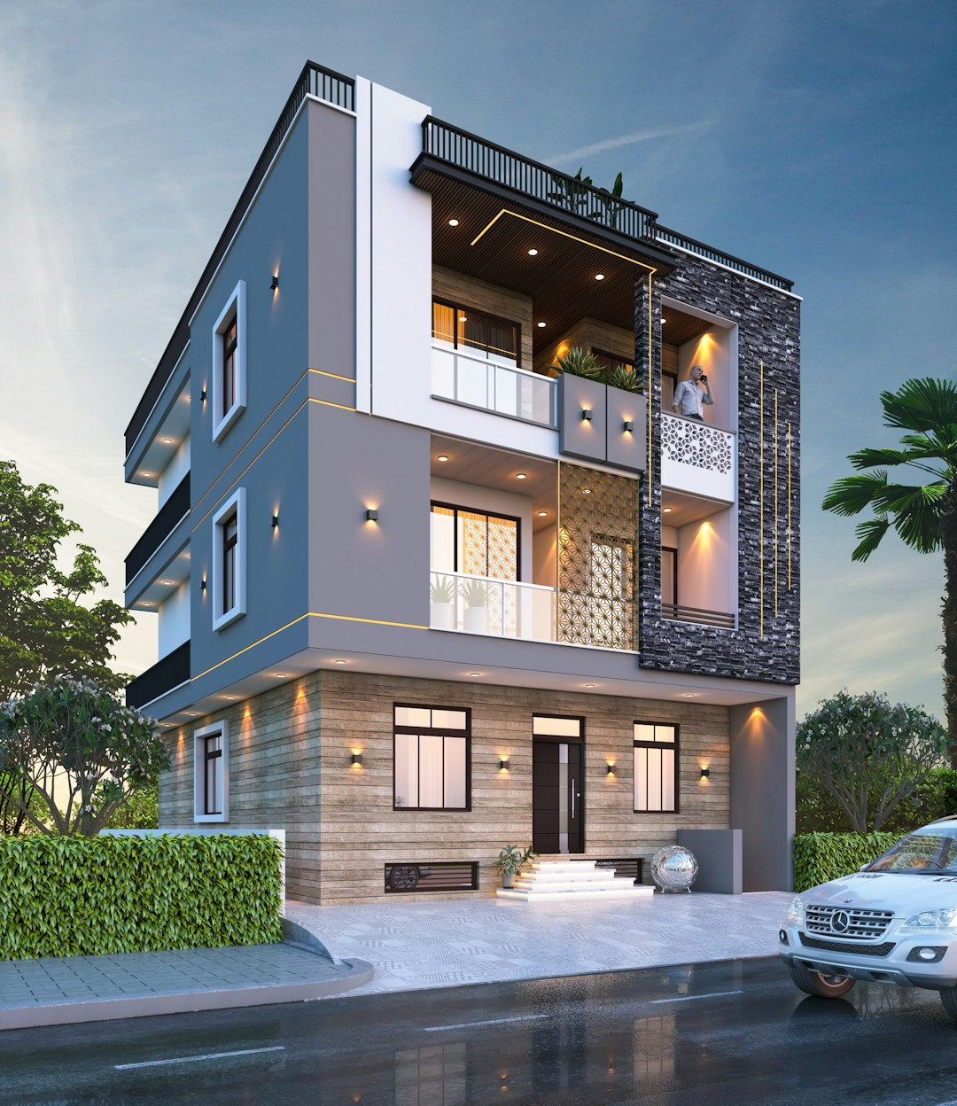 The image depicts a modern three-story house with a contemporary design. The exterior is primarily white with gray accents and features large windows that offer ample natural light. A balcony extends from the second floor, providing an outdoor space. The house is surrounded by lush greenery and palm trees, creating a serene atmosphere. contact us now for house map and designing work 🌐 www.nakshabanwao.com 📞 +91-9549494050
